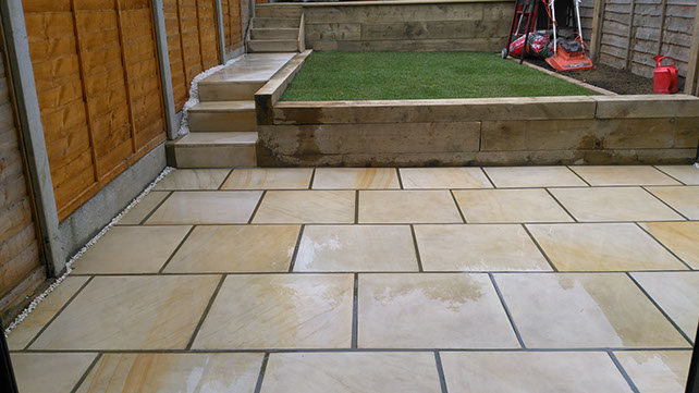 Joseph Mat Landscape patio with sawn  sandstone and steps, terraces with sleepers and decking